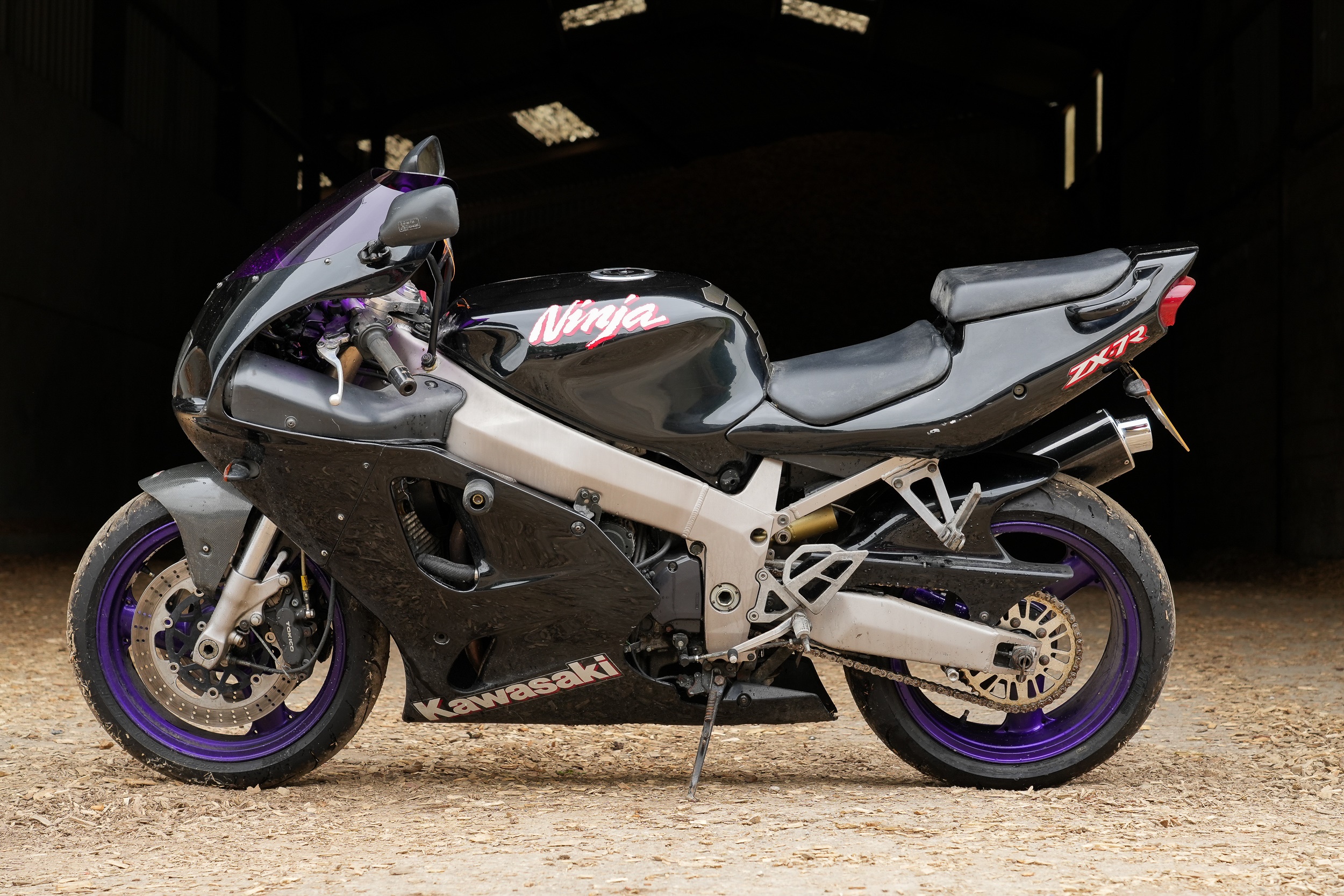 Black 1997 Kawasaki Ninja ZX-7R with red graphics and purple wheels